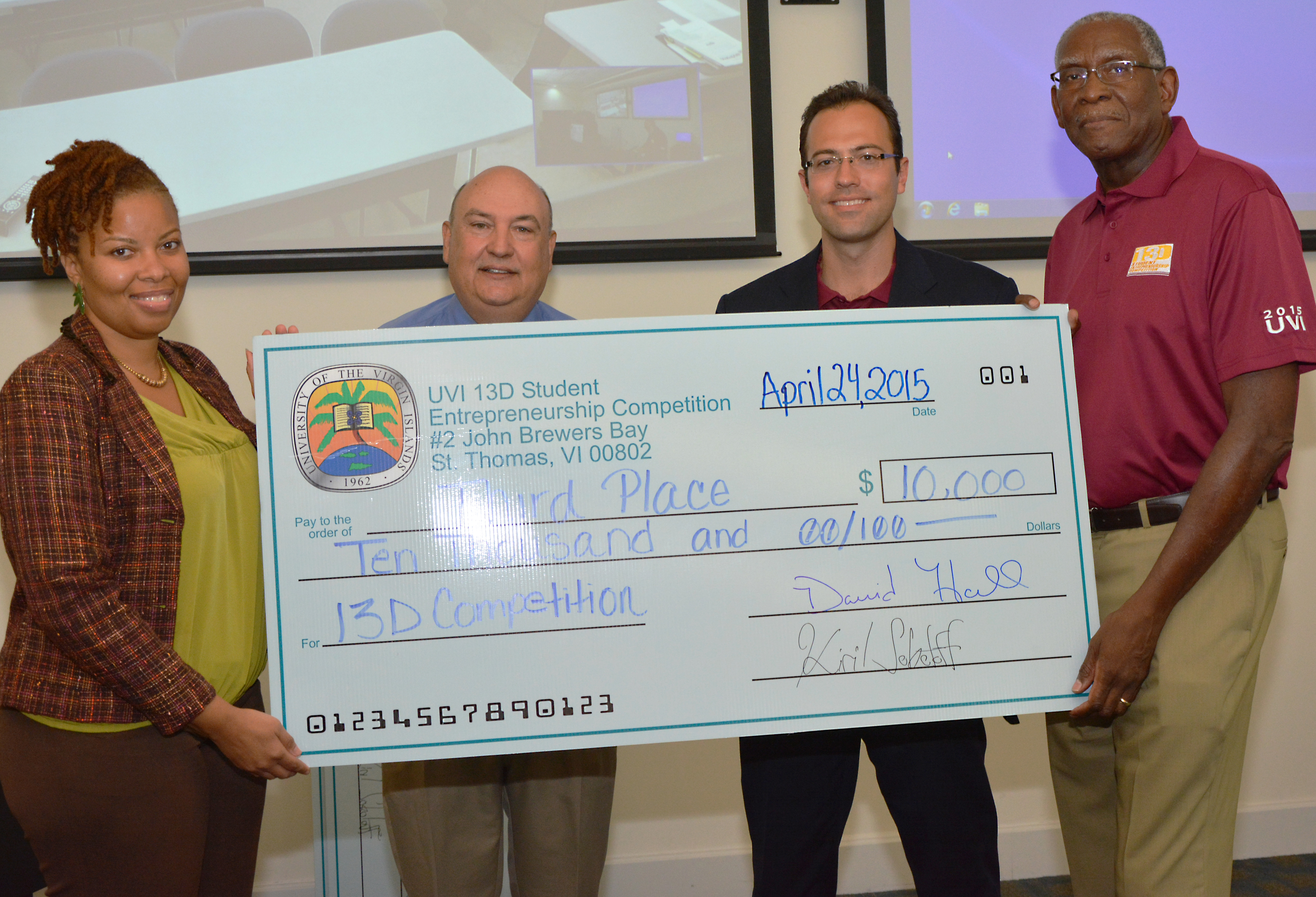 UVI 13D Winner Gelise David, 13D Coordinator Dr. Glenn Metts, Jonathan Gula of 13D and UVI President David Hall pose for a photo after the 13D Student Entrepreneurship Competition. 